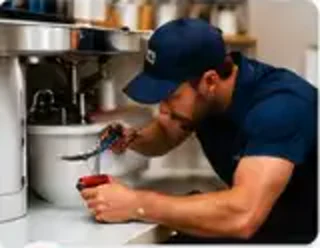 Plumber repairing a sink